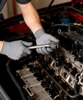 Mechanic using 96 Piece 3/8 Inch Drive Impact Socket Set with wrench on car engine, showcasing CR-V steel socket in action