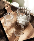 High Quality Clear Glass Storage Jars With Chic Vertical Stripes For Preserving Coffee Beans Candy Sugar Salt And Tea Kitchen Countertop Organizer That Keeps Your Snacks Lowkey Perfect And Dope on a wooden board with sugar cubes.