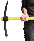 Person holding Beast Mode Heavy Duty Forged Mattock With Adze And Ergonomic Non Slip Handle for gardening and outdoor use.