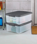 18 Pack Plastic Storage Bins With Lids 25 Quart Gray Shelf Totes stacked in garage for home organization.