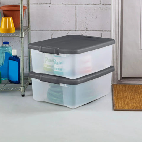 18 Pack Plastic Storage Bins With Lids 25 Quart Gray Shelf Totes stacked in garage for home organization.