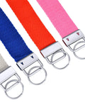 Close-up of colorful fabric wristlets with metal hardware from 60 Set Key Fob Hardware Kit With 1In Base 25mm And 0.63In Inner Top 16mm 0.9In Outer Top 23mm Includes 60 Fobs And 60 Split Keyrings Plus Pro Pliers With Rubber Tips For Easy Wristlet Attachments On Fabric Ribbon Or Webbing.