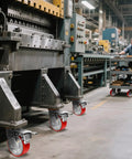 Rock Solid Heavy Duty Caster Wheels With Tough Polyurethane Treads And Rustproof Cast Iron Cores For Platform Dollies And Military Gear 4000 Lb Rating Two Brake Two Swivel on industrial cart in factory.