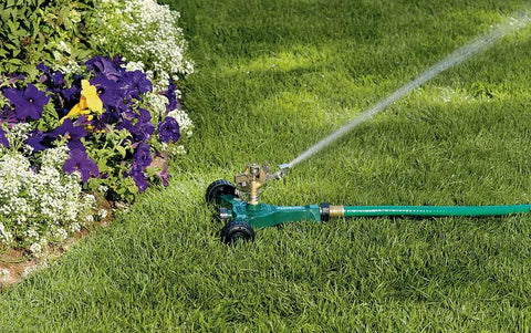 No-Fuss Half Inch Brass Impact Sprinkler With Metal Wheel Base Delivers Even Water Distribution For Lawn And Garden in use