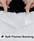 Close-up of hands showing the elastic edge and soft flannel backing of a black Elastic Fitted Flannel Backed Vinyl Tablecloth For 6ft Folding Tables
