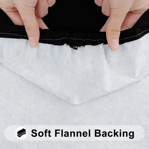 Close-up of hands showing the elastic edge and soft flannel backing of a black Elastic Fitted Flannel Backed Vinyl Tablecloth For 6ft Folding Tables