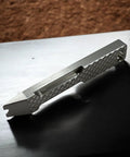 Everyday Carry Mini Pry Bar Keychain With Screwdriver And Box Opener Heavy Duty Stainless Steel EDC Tool on table in profile view