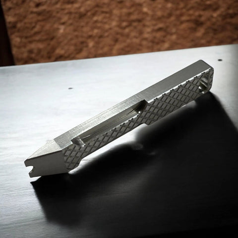 Everyday Carry Mini Pry Bar Keychain With Screwdriver And Box Opener Heavy Duty Stainless Steel EDC Tool on table in profile view