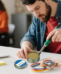 Man using No Clean Solder Flux Paste for electronics repair and PCB soldering, showing precision application on circuit boards.