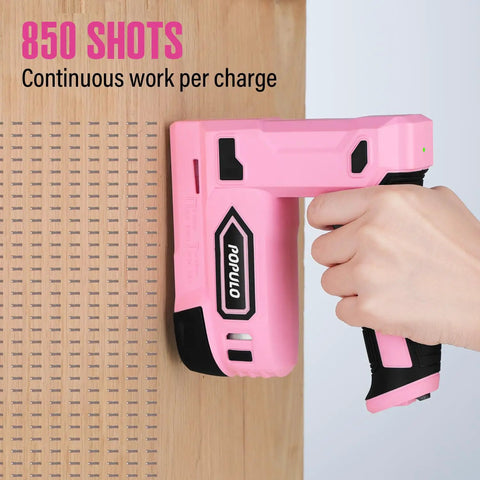 Hand holding Pink Cordless 4V Electric Staple Gun 2 In 1 Stapler And Brad Nailer USB C Rechargeable against wood surface.