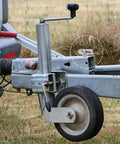Rock-Solid Alloy Trailer Locking Pin With Long Screw For Secure Hitch Connector seen on trailer tongue with wheel support.