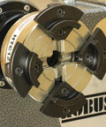 Close-up of HTC125 5 Inch Four Jaw Woodturning Chuck Kit mounted on lathe, showing chrome-plated steel body and dovetail jaws.