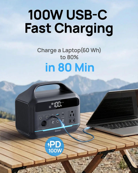 Ultra Portable Power Station 600W Peak 1200W, 288Wh LiFePO4 Solar Generator with laptop on wooden table, mountains in background