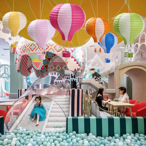 Hot Air Balloon Paper Lantern Decor Set Of 6 With Striped Blue Green Pink Orange Yellow Patterns 12 Inch Diameter And 16 Inch Expanded Height Perfect For Weddings Birthday Engagements Christmas Party Decor Party Ready Vibe hanging in a play area with children and ball pit