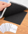 Hand lifting carpet showing black hook and loop mat, part of Non Slip Rug Tape And Corner Anchors Pack, 10 pieces visible.