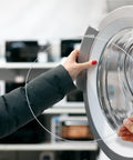 Close-up of a person holding stainless steel washing machine door boot spring clamp for front load washers
