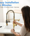 Person installing AIMADI Brushed Gold Kitchen Faucet with Pull Down Sprayer on a white sink in a modern kitchen.