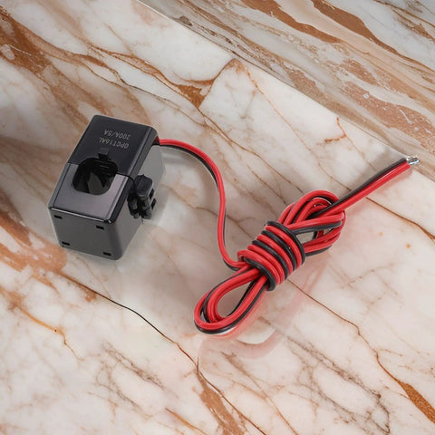 Premium Split Core Current Transformer Clamp Sensor 200A with wires on marble surface for EV charging stations and grid tracking.