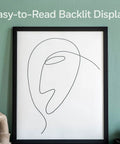 Room with wall art and 7 Day Flexible Programmable Thermostat With Extra Large Backlit Display White for easy reading.