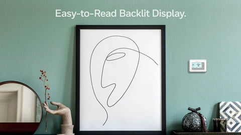 Room with wall art and 7 Day Flexible Programmable Thermostat With Extra Large Backlit Display White for easy reading.