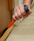 10-Inch Molding Bar With Integrated Nail Dimpler, Heavy-Duty Carbon Steel Pry Bar in use, pulling trim with shock absorbing grip