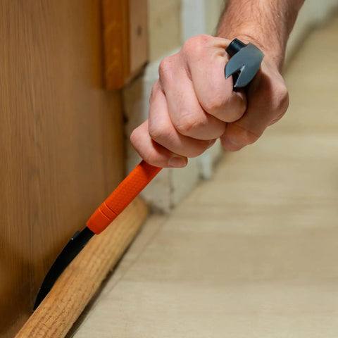 10-Inch Molding Bar With Integrated Nail Dimpler, Heavy-Duty Carbon Steel Pry Bar in use, pulling trim with shock absorbing grip