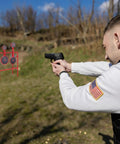 Man aiming at Double Spinner Shooting Targets Three Eighths Inch Thick Steel Auto Reset Target System With Four Plate Sizes