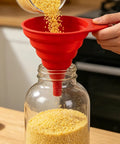Four Pack Foldable Silicone Funnels Designed To Ditch The Drips And Streamline Liquid Transfers Between Kitchen Bottles Home Bars And Road Trip Gear For A Hassle Free Pour Every Single Time, red funnel pouring grains into jar.