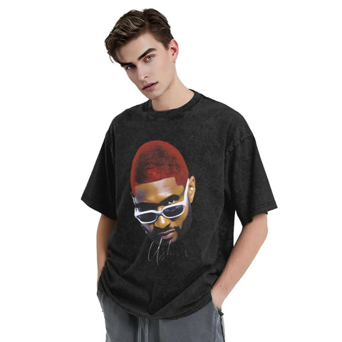 Man wearing a black oversized t-shirt featuring a graphic design of a person with sunglasses and red hair.