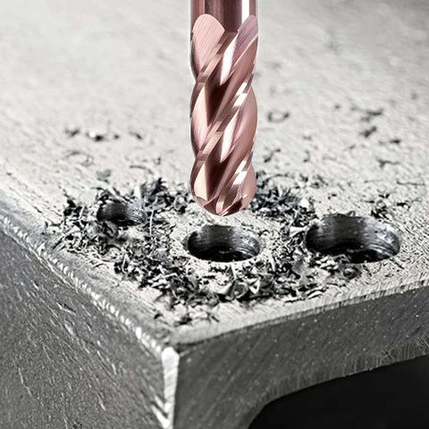 Close-up of TiSiN-coated 4-flute ball-nose end mill, 1/16 in, above a metal workpiece with chips