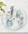 Rain Collection Lazy Susan Turntable Organizer showing perfumes on clear 9-inch round plastic storage for countertop