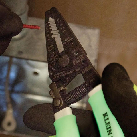 Glow In The Dark Grips Wire Stripper And Cutter With Serrated Curve Nose For 10 To 18 AWG Solid And 12 To 20 AWG Stranded Wire Pro Grade Tool Made In USA in electrician's hand