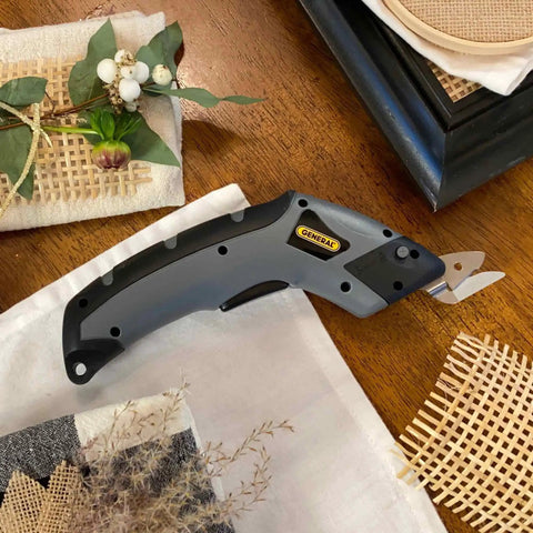 Cordless Electric Craft Scissors With Two Blades And Charger One Button Operation displayed on a wooden crafting table