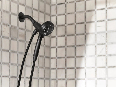 Matte Black Three Point Five Inch Six Function Detachable Handheld Showerhead With Magnetic Docking System installed on tile wall
