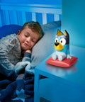Child sleeping beside Bluey Nightlight For Kids 2 In 1 Toddler Lamp And Flashlight With Auto Off Timer on nightstand