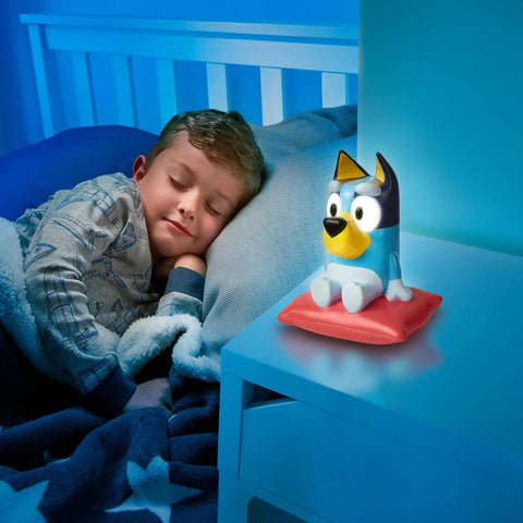 Child sleeping beside Bluey Nightlight For Kids 2 In 1 Toddler Lamp And Flashlight With Auto Off Timer on nightstand