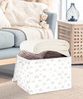 Heavy Hitter Collapsible Storage Bin With Secure Flip Top Lid and Reinforced Carry Handles, storing rolled blankets in a living room setting.