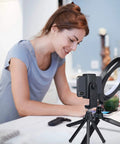 Woman using 6 Inch Ring Light With Tripod Stand For Desk Use Perfect For YouTube Vids, Makeup Tutorials And Selfies in kitchen