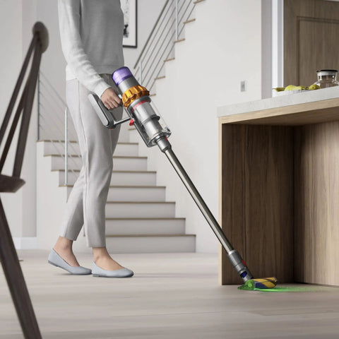 Person using V15 Detect Total Clean Extra Refurbished Premium Vacuum Cleaner With Laser Dust Detection on kitchen floor
