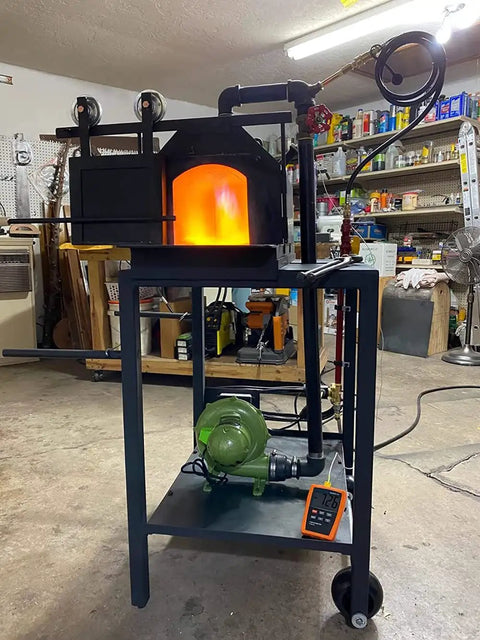 Electric Blacksmith Forge Blower 110V 250W for Coal Fires in workshop setup, showing lit forge and blower unit.
