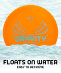 Orange Gravity Disc Golf Starter Set disc floating on water, showcasing lightweight 120-130g plastic for easy retrieval.