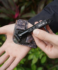 Archery Release Aid For Compound Bows With 360 Degree Rotating Trigger Wristband in use, showing adjustable camouflage design.