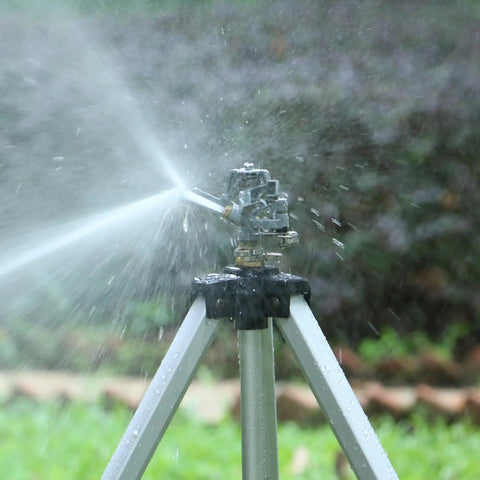 Heavy Duty Impact Sprinkler On Tripod Base With Extra Tall Pulsating Metal Sprinkler for Large Yards and Gardens Telescoping Legs Waters Up To 90 Ft Diameter Durable Tripod System in action on grass