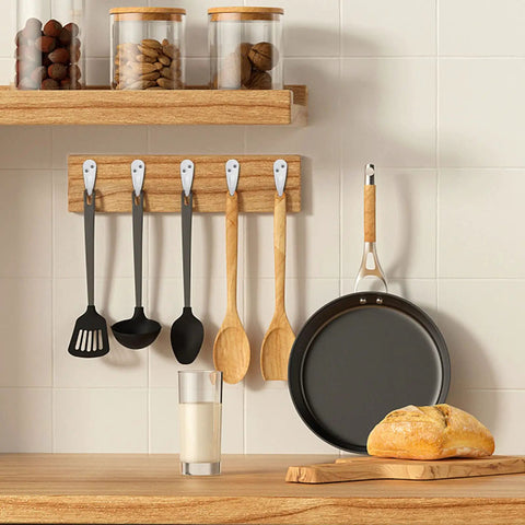 Heavy Duty Metal Coat Hooks Wall Mounted 10 Pack Single Prong Robe Hanger holding kitchen utensils in white kitchen