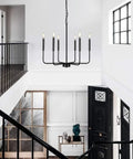 Black Farmhouse Six Light Pendant Chandelier in modern entryway, rustic matte black ceiling fixture for a warm glow.