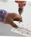 Close-up of VILLFUL 2-pack stainless steel door hinges with ball bearings; installer drills mounting holes