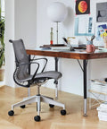 Top Shelf Adjustable Height Table Legs Set Of Four Black Modern Stainless Steel Office And Activity Desk Hardware Heavy Duty Replacement Base Built Different Slick Finish with a gray office chair and wooden desk.