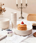 36 Piece Reusable Wheat Straw Dinnerware Set For Six With Plates, Bowls, and Cups displayed with pancakes on a marble table
