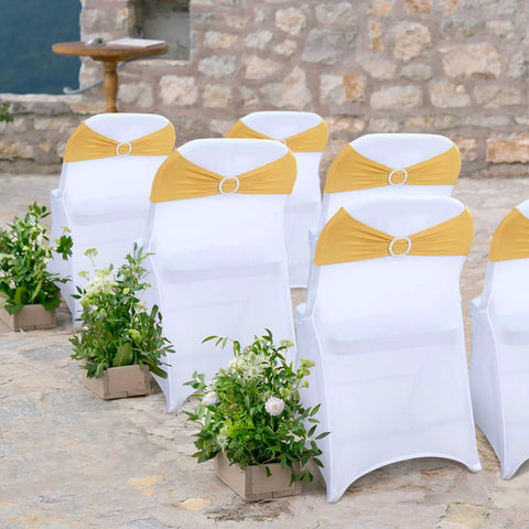 Front view of white banquet chairs with gold spandex chair sashes and ring sliders.