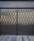 Heavy Duty Double Folding Security Gate Eighty Seven Inches Tall By One Hundred Fifty Inches Wide Built Like A Tank With Fourteen Gauge Steel And Black Powder Coat For Serious Perimeter Lock Down, showcasing the gate's closed configuration.